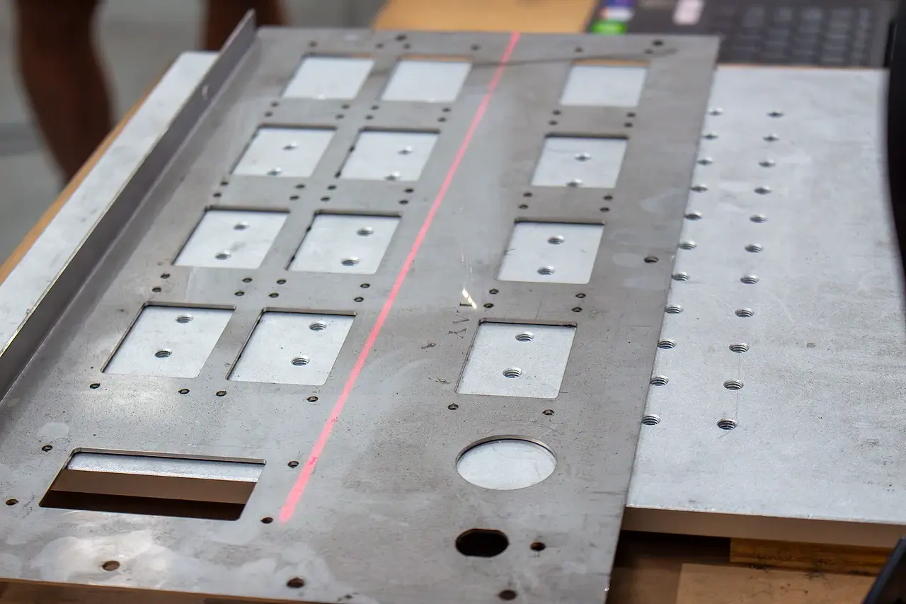 A red marking laser tracking across a fabricated controller panel