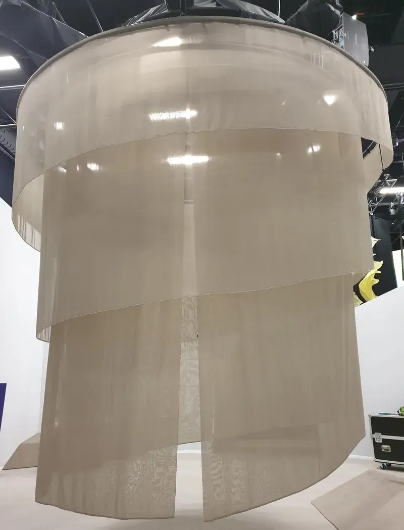 Tiered circular sheer voile centrepiece suspended over an event floor