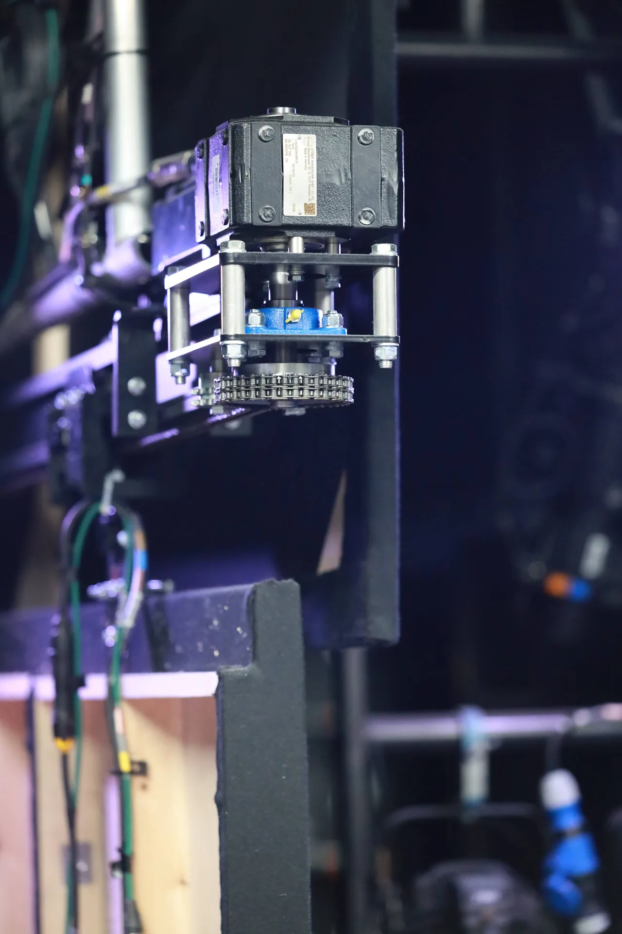 A chain-drive motor unit on a Triple E track system backstage