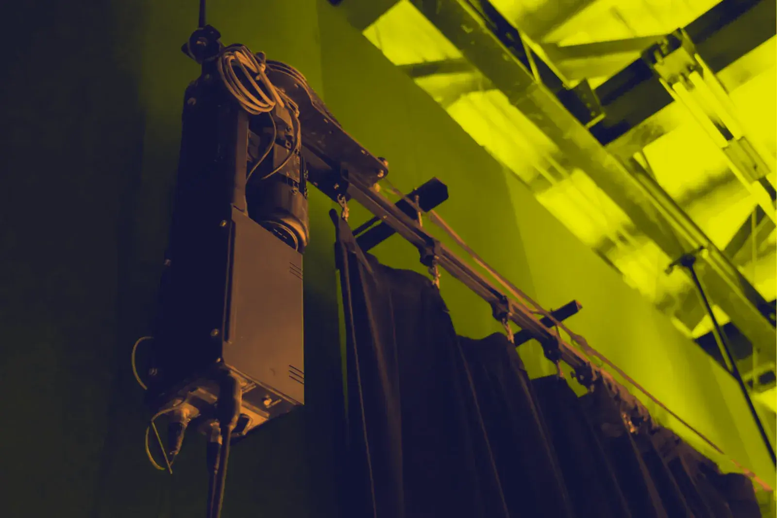 Electric chain hoist rigged to overhead truss
