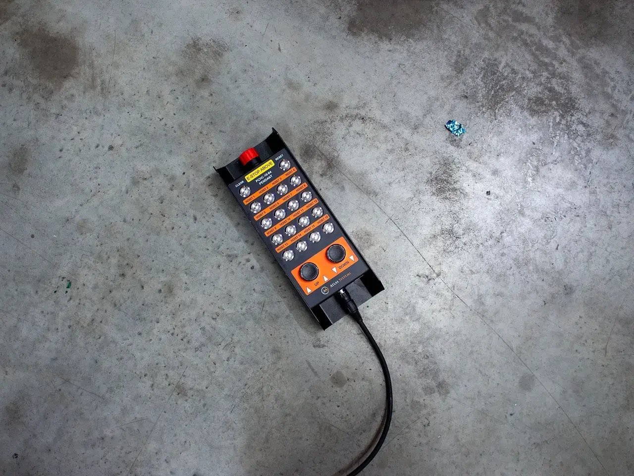 Technician holding a hoist control pendant during functional testing