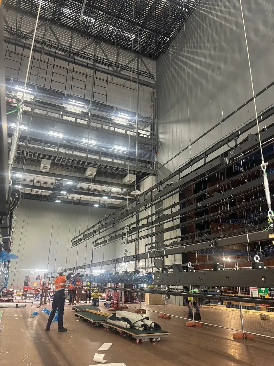 Installed lighting bars and pipe grid overhead backstage