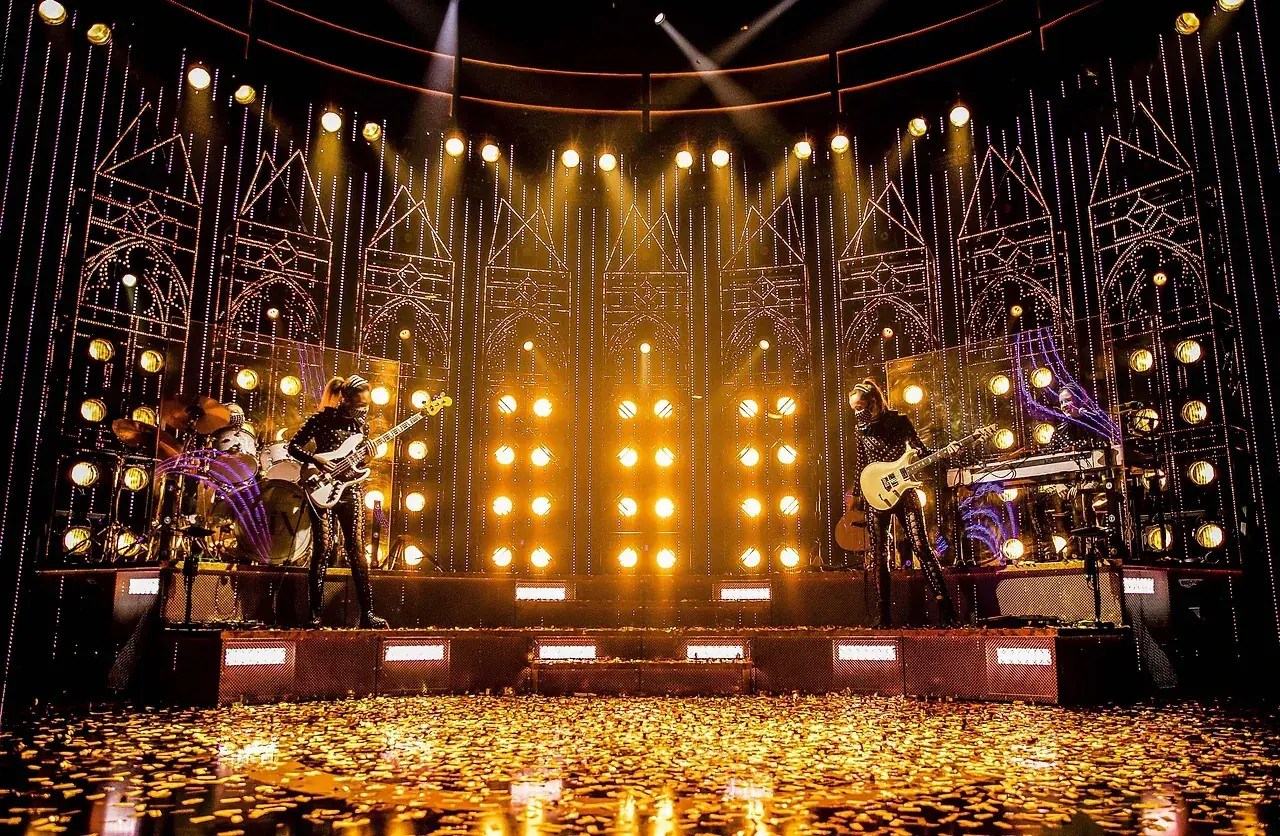 The gold-lit touring set of SIX the Musical on stage