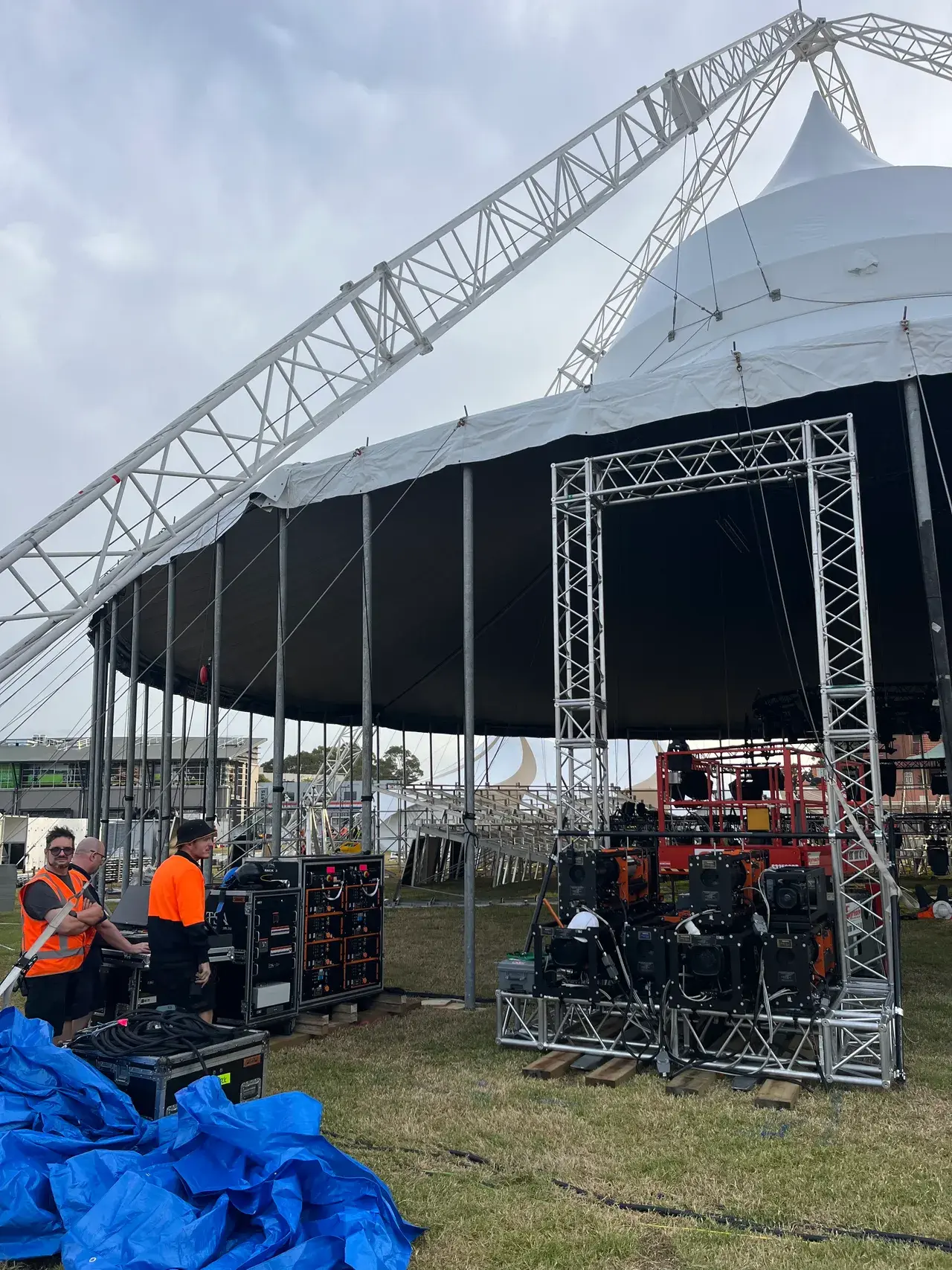 The Come Alive circular arena truss lit at night during load-in