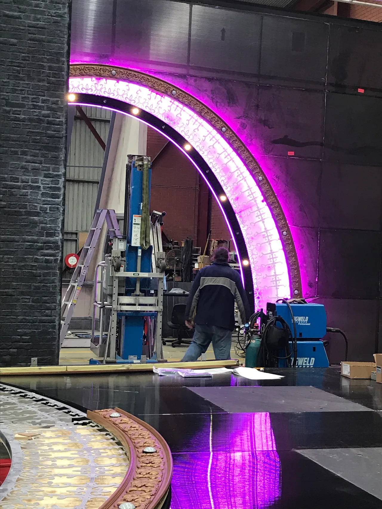 The LED-lit ornate proscenium arch for Moulin Rouge under construction in the scenic workshop