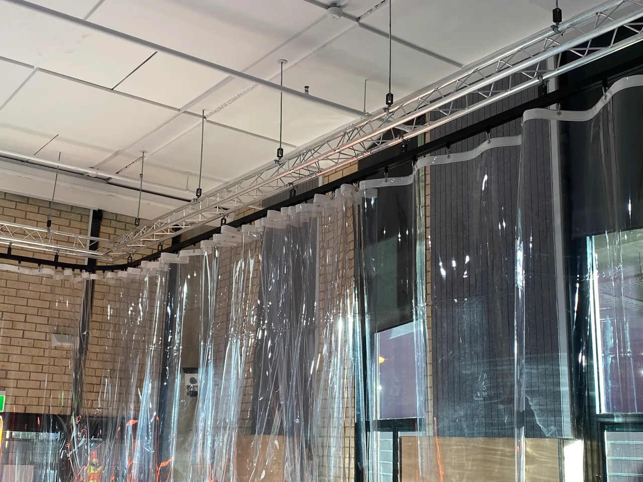 Clear PVC curtains on a curved ceiling track in the Deakin University Maker Space